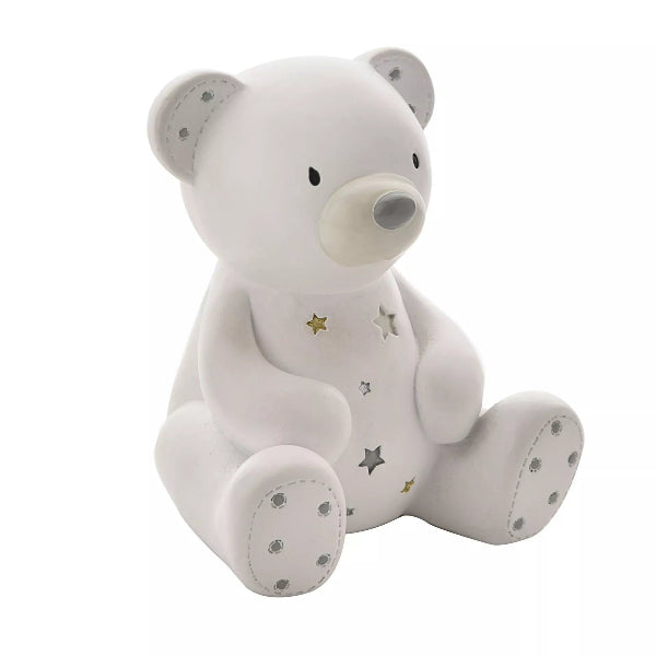 White teddy bear with star patterns on a white background