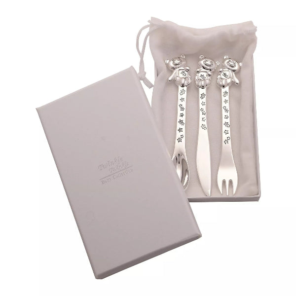 Silver cutlery set with decorative handles in a white pouch on a white background