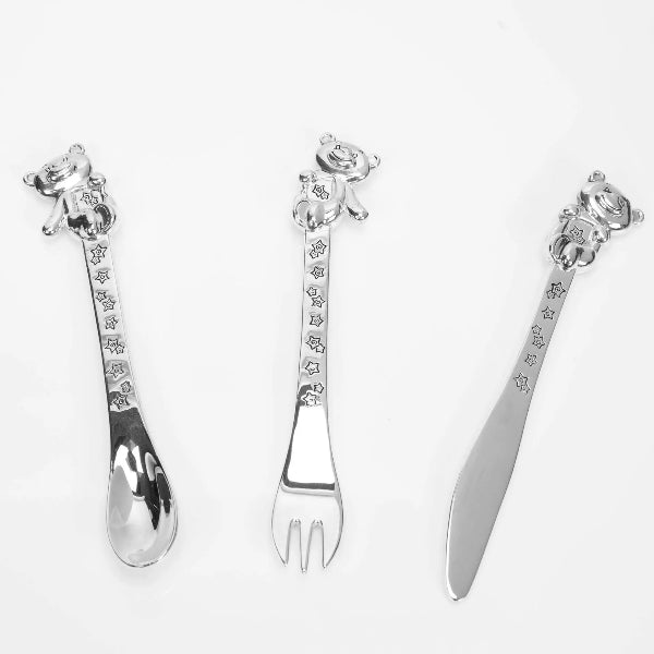Set of silver cutlery with decorative handles on a white background