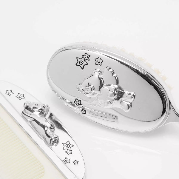 Silver spoon and fork with engraved designs on a white background