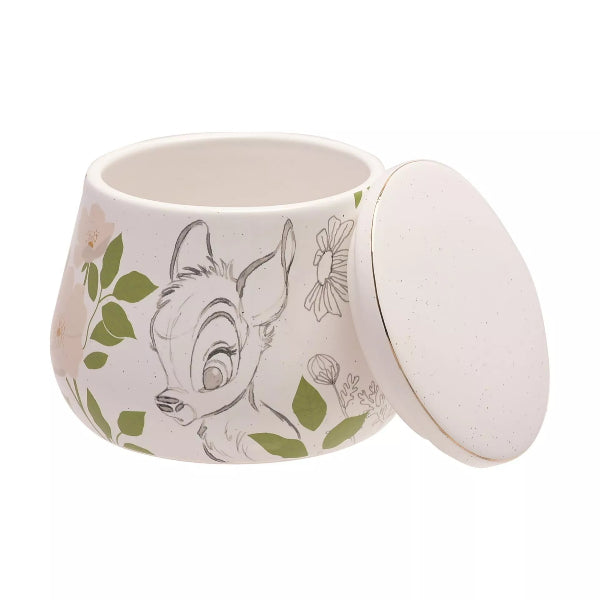 Ceramic container with a lid featuring an animal design and floral elements on a white background