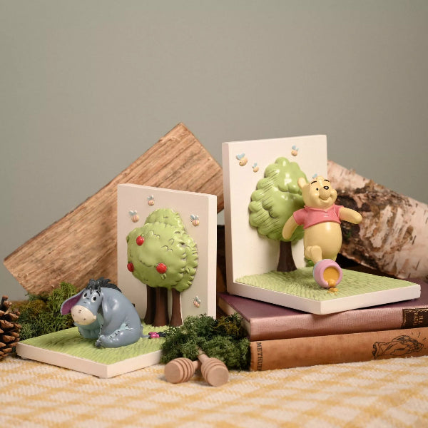 Decorative bookends with Winnie the Pooh and Eeyore on a neutral background