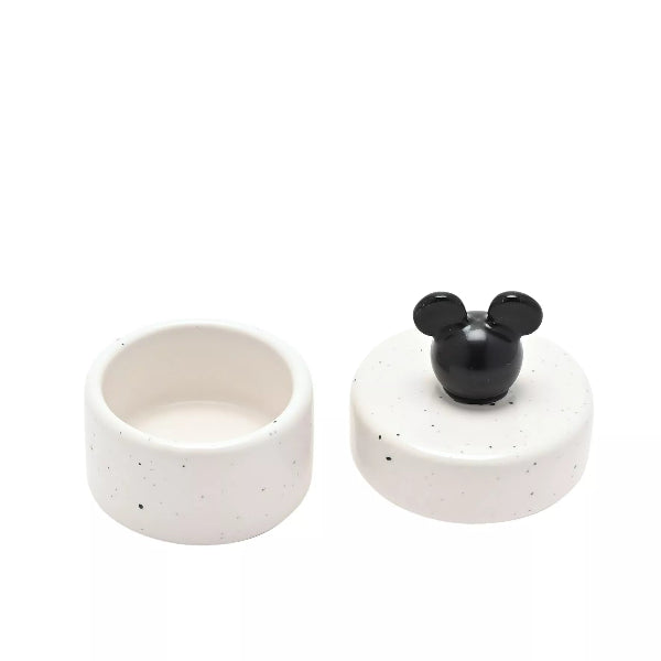 Speckled ceramic container with black mouse ear design on a white background