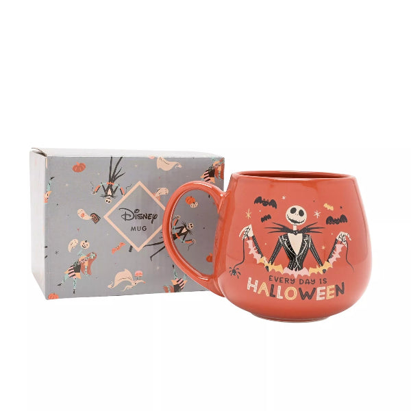 Orange mug with Halloween design and text, featuring a box with Disney branding.