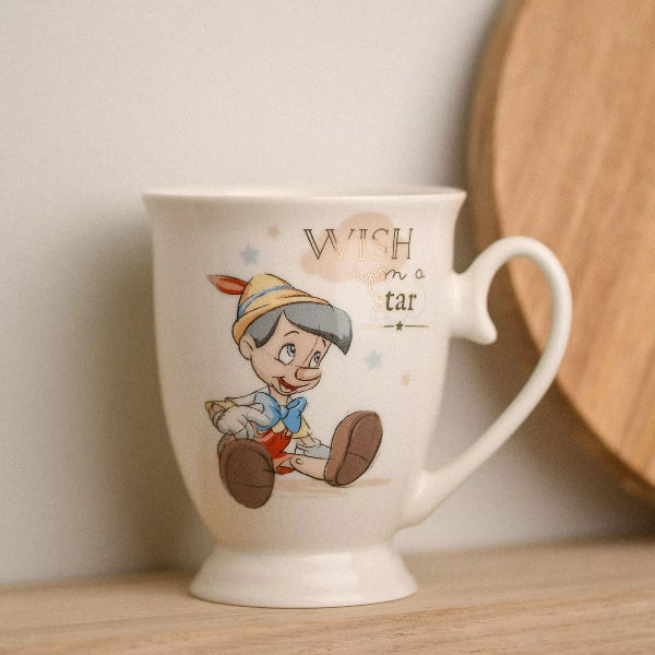 Mug with cartoon character and 'Wish upon a star' text on a wooden surface