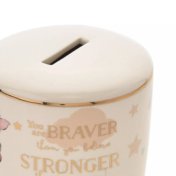 Ceramic money box with motivational quote and decorative elements on a white background