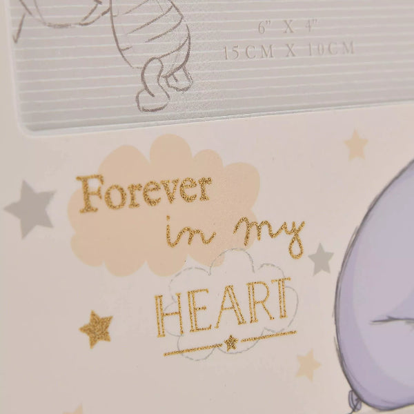 Memorial card with 'Forever in my heart' text and baby items on a beige background