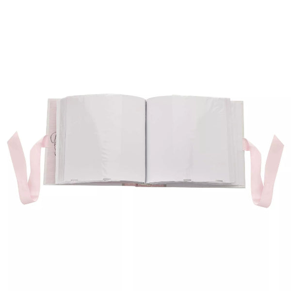 Open book with pink ribbon on a white background