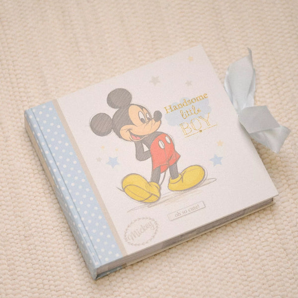 Book with a cartoon character on the cover, tied with a ribbon, on a textured surface