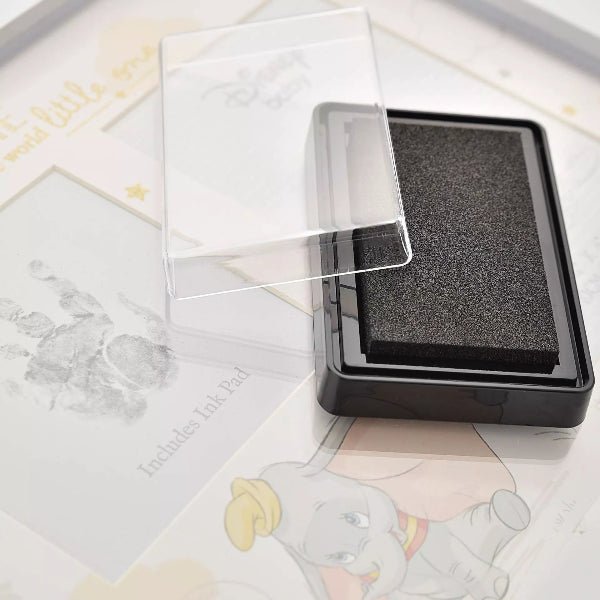 Clear stamp pad on a white surface with cartoon characters in the background