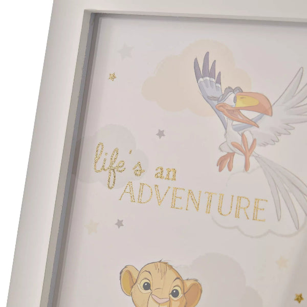 Framed artwork with a cartoon character and 'life's an adventure' text.