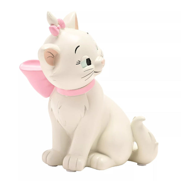 Cat figurine with pink bow and collar on a white background