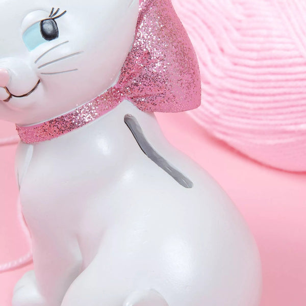 White rabbit plush toy with pink glittery accents on a pink background