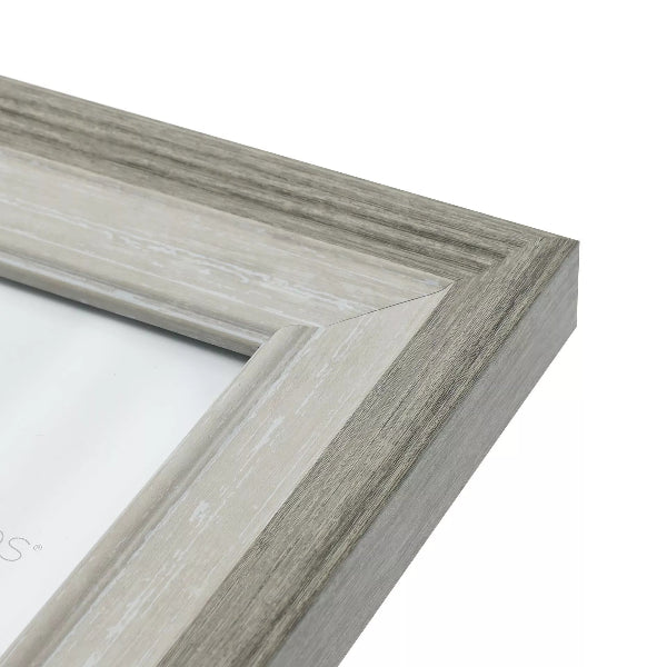 Close-up of a gray wooden picture frame corner on a white background