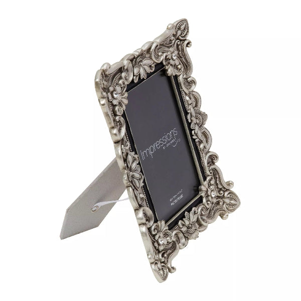 Decorative silver photo frame with a on a white background