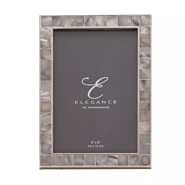 A rectangular picture frame with a silver-toned metallic border made of small square tiles, shown on a plain white background. The frame holds a dark gray insert card with the brand name 'Elegance By Impressions' and dimensions printed at the bottom.
