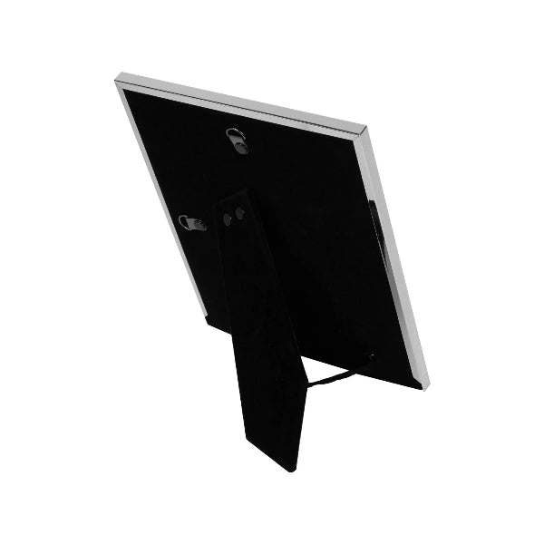 Black rectangular object with a metallic rim on a white background