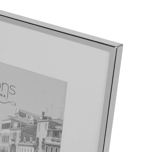 Close-up of a silver picture frame with a photo inside showing buildings.
