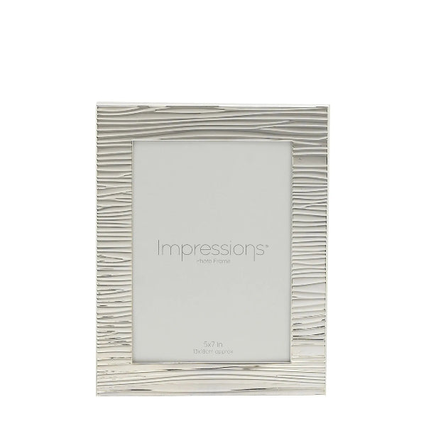Silver photo frame with wavy design on a white background