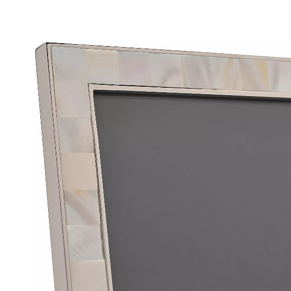 Decorative mirror with a shell border on a white background
