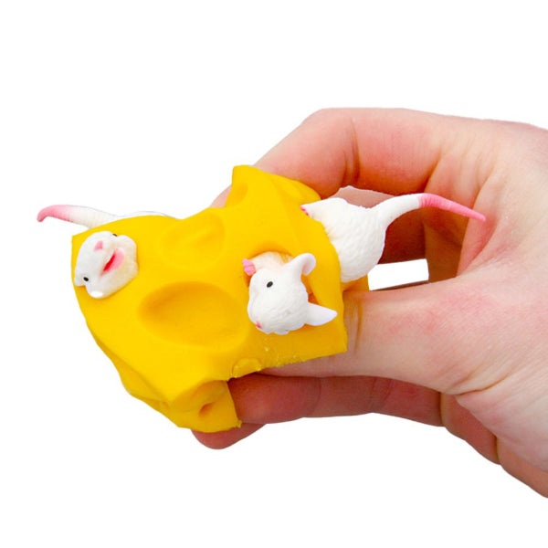 Hand holding a yellow mouse trap with three small white mice on a white background