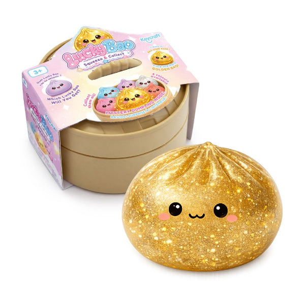 Gold plush toy with a smiling face next to its packaging on a white background